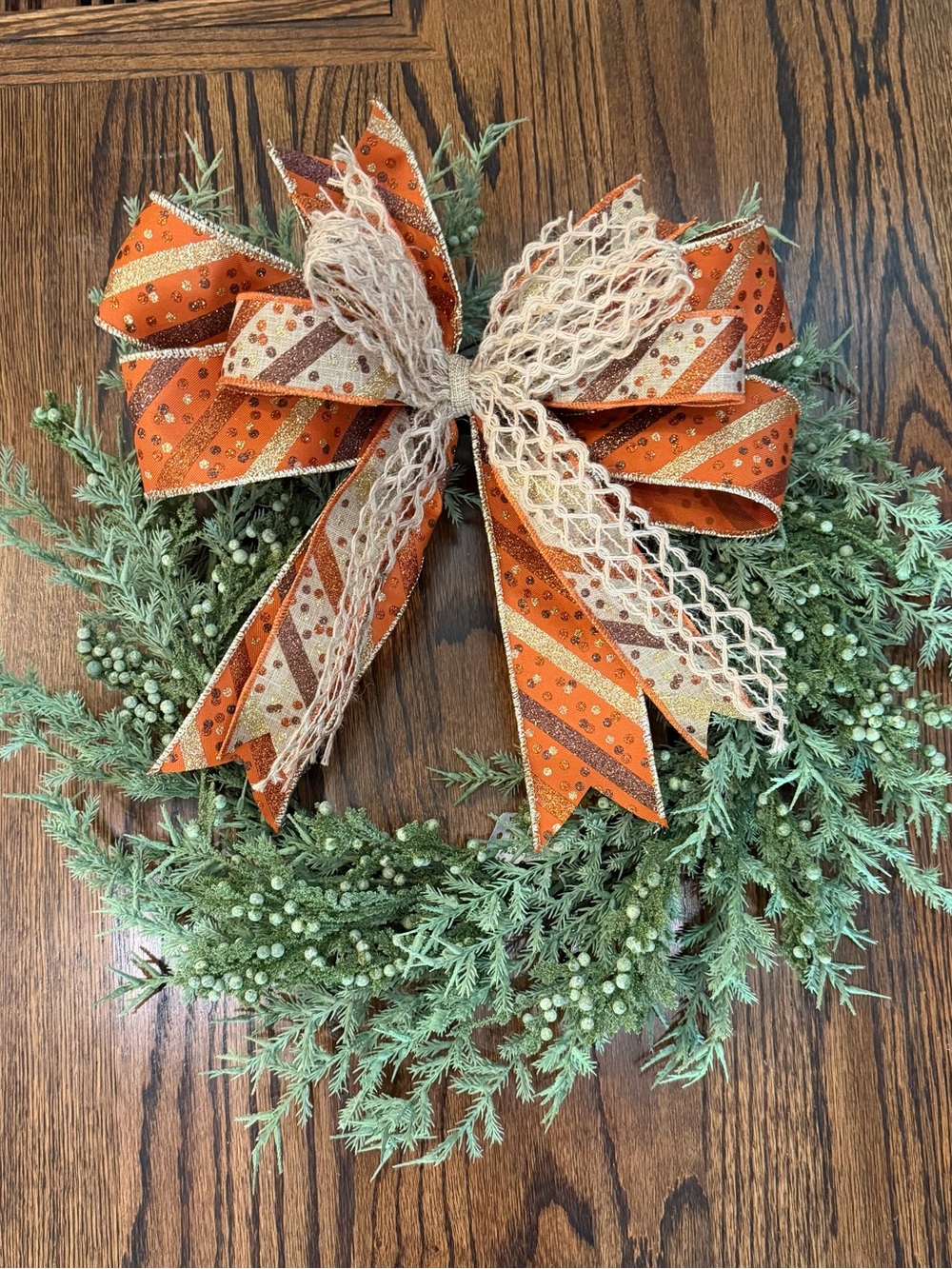 Green Cedar Holiday Wreath with Orange Patterned Bow